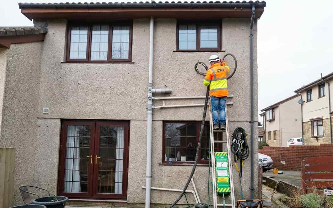 Cavity wall insulation being injected into an exterior wall
